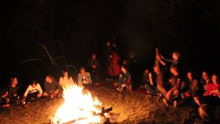 chaleureuse atmosphère d'un vrai feu dans la nuit, avec chant et guitare